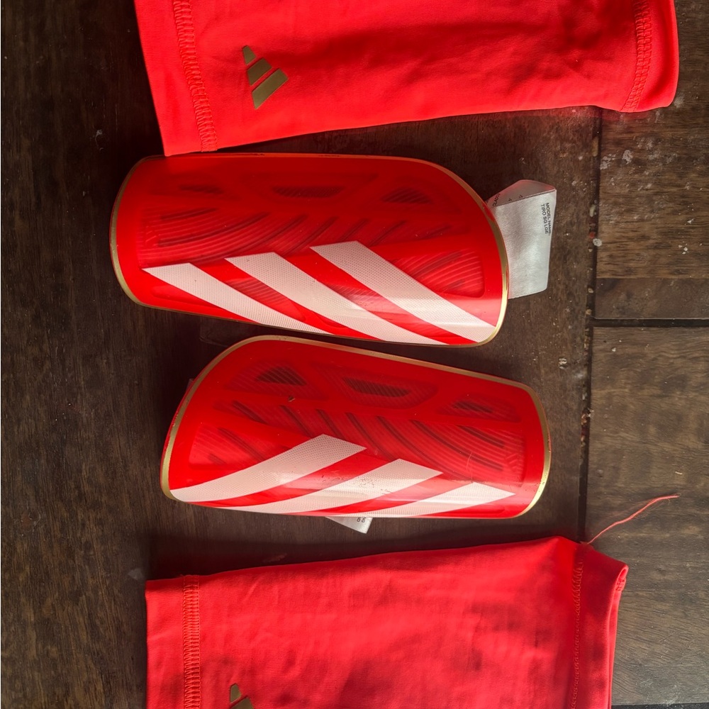 Kids Adidas bright orange and White Shin Guards with Gold Trim for Soccer